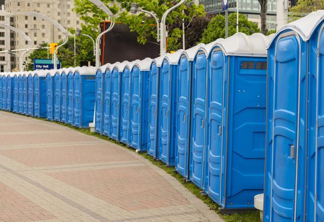 a row of portable restrooms set up for a large athletic event, allowing participants and spectators to easily take care of their needs in Litchfield Park